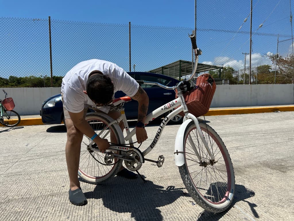 Adjusting a beach cruiser bicycle in Mexico