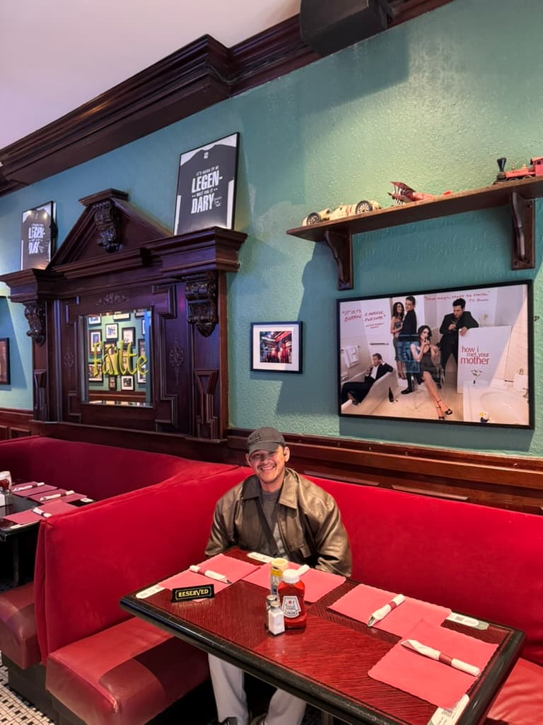 Sitting at a booth in a How I Met Your Mother themed restaurant in New York