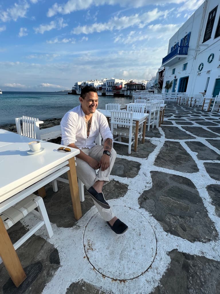Sitting at a seaside cafe table in Mykonos